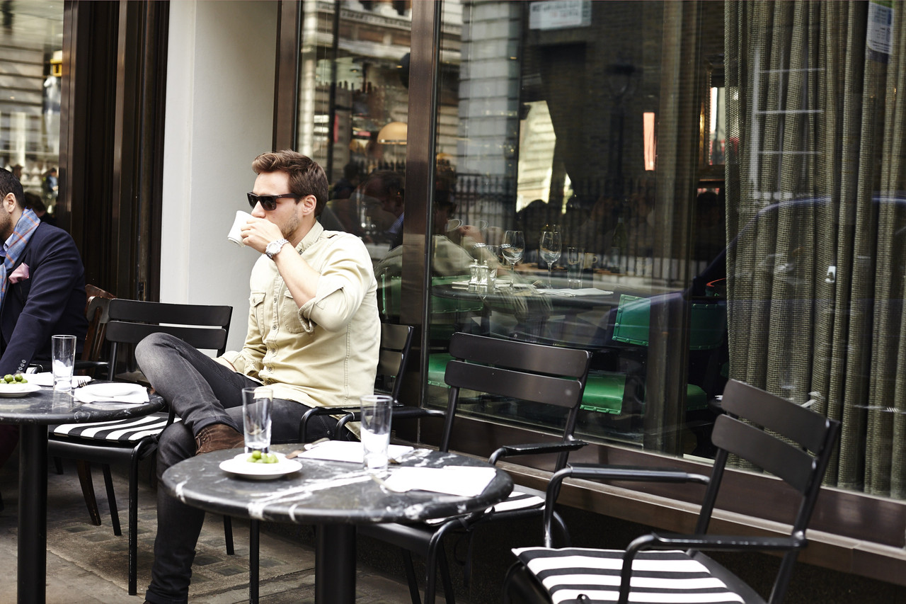 A man drinking coffee outside Cecconi's Mayfair